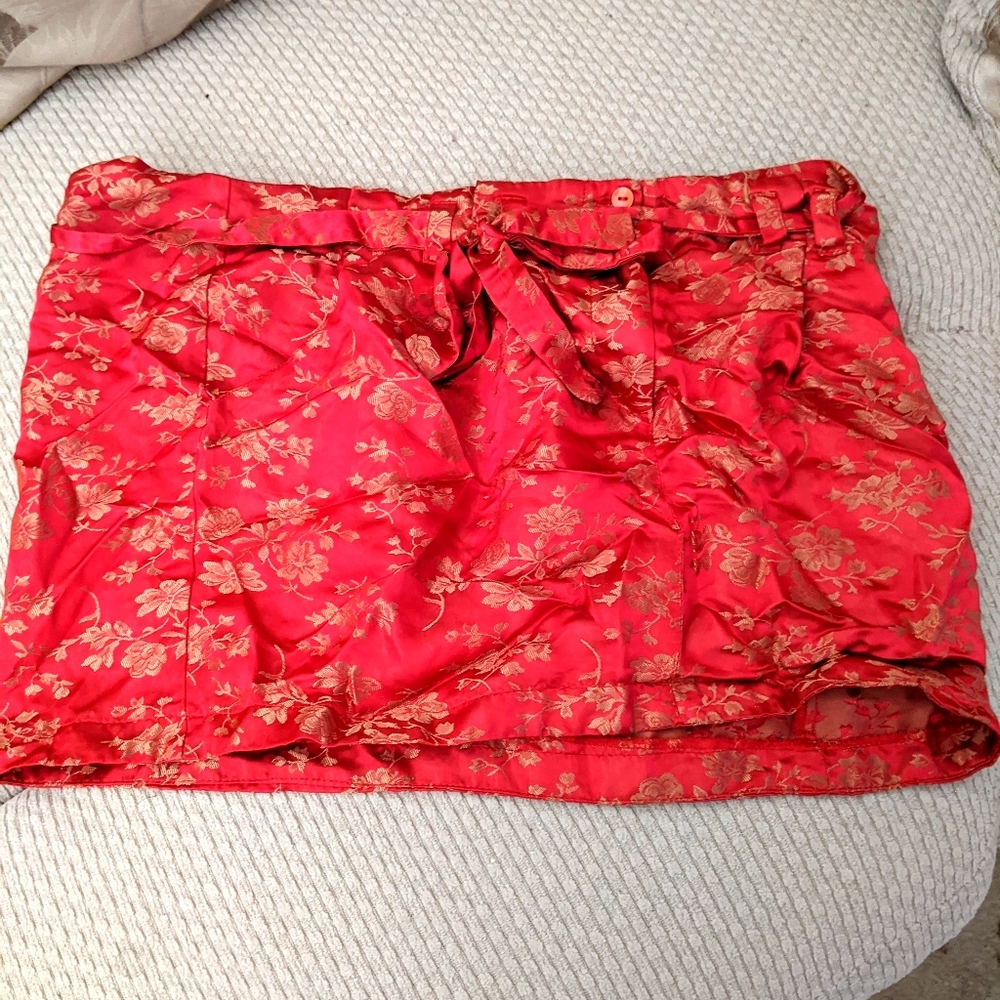 Vibrant red faux silk mini-skirt with gold flowers